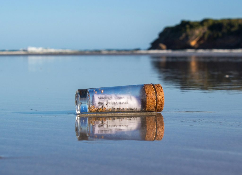 a message in a bottle sitting on the beach